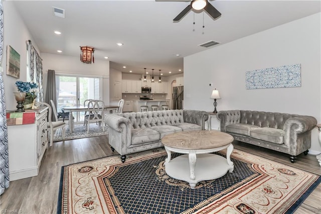 151 Outrigger Ln, Troutman, NC 28166 - living area with light wood finished floors, ceiling fan, and recessed lighting