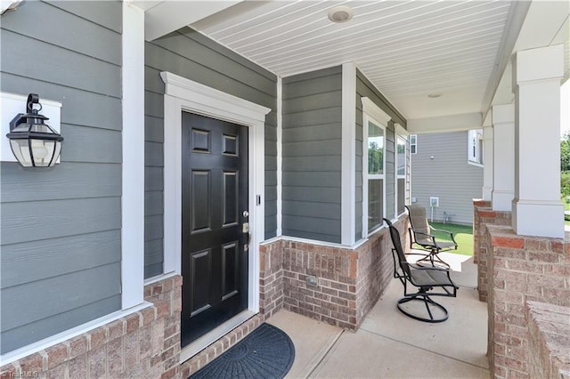 151 Outrigger Ln, Troutman, NC 28166 - doorway to property with covered porch and brick siding