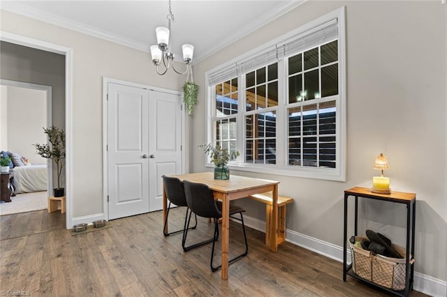 dining area with baseboards, ornamental molding, and hardwood / wood-style floors