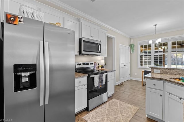 kitchen with pendant lighting, crown molding, appliances with stainless steel finishes, white cabinetry, and light wood-type flooring