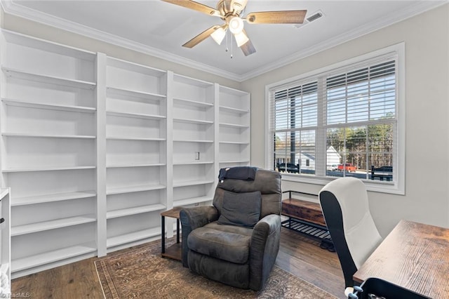 office area featuring a ceiling fan, visible vents, ornamental molding, and wood finished floors