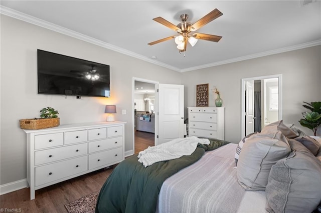 bedroom with baseboards, a ceiling fan, dark wood-type flooring, ensuite bathroom, and crown molding