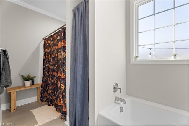 full bathroom featuring shower / bath combo, baseboards, and crown molding