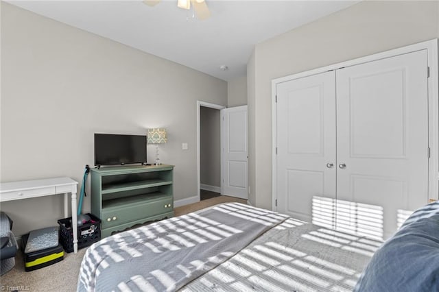 carpeted bedroom with baseboards, a ceiling fan, and a closet