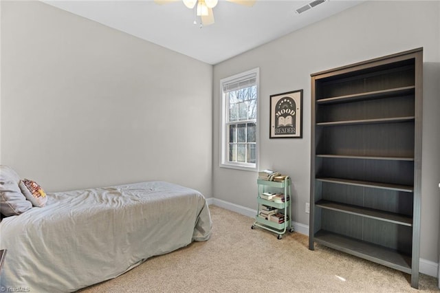 carpeted bedroom featuring ceiling fan, visible vents, and baseboards