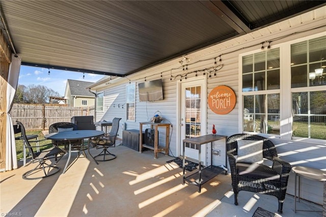 view of patio / terrace featuring outdoor dining area and fence