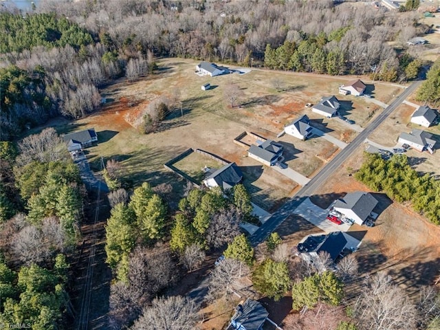 birds eye view of property featuring a view of trees