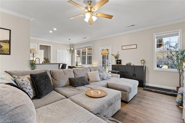 living area with baseboards, a ceiling fan, ornamental molding, wood finished floors, and recessed lighting