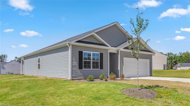 view of front of house featuring a garage and a front yard