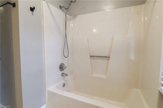 bathroom with bathing tub / shower combination