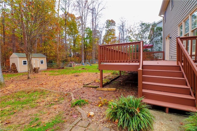 view of yard featuring a deck and a storage unit