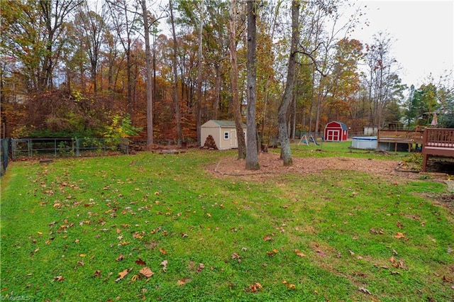 view of yard featuring a shed and a wooden deck