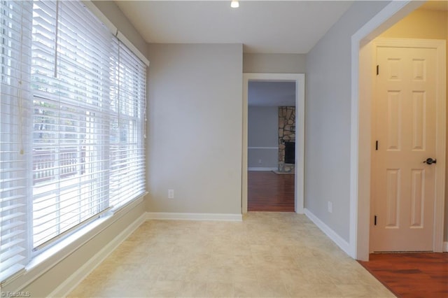 unfurnished room with a fireplace and light hardwood / wood-style floors