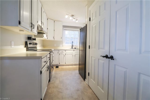 kitchen featuring white cabinetry, sink, electric range, and refrigerator