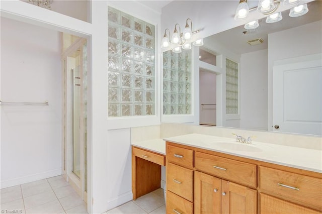 bathroom with tile patterned flooring, vanity, and a shower with shower door