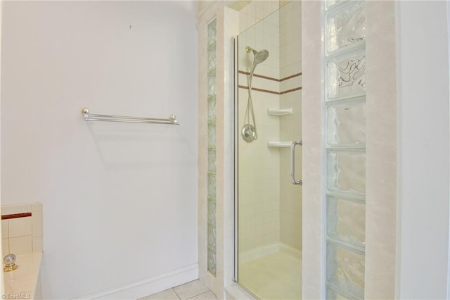 bathroom with walk in shower and tile patterned flooring