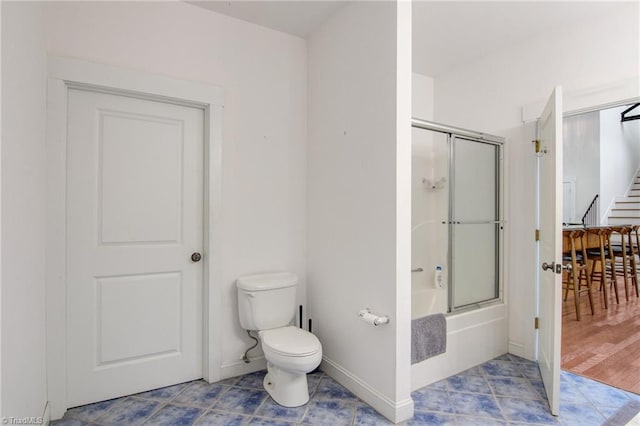 bathroom with shower / bath combination with glass door, hardwood / wood-style floors, and toilet