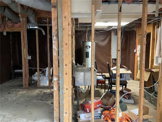 miscellaneous room with water heater and a sink