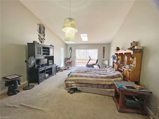 bedroom with carpet flooring, vaulted ceiling with skylight, and baseboards