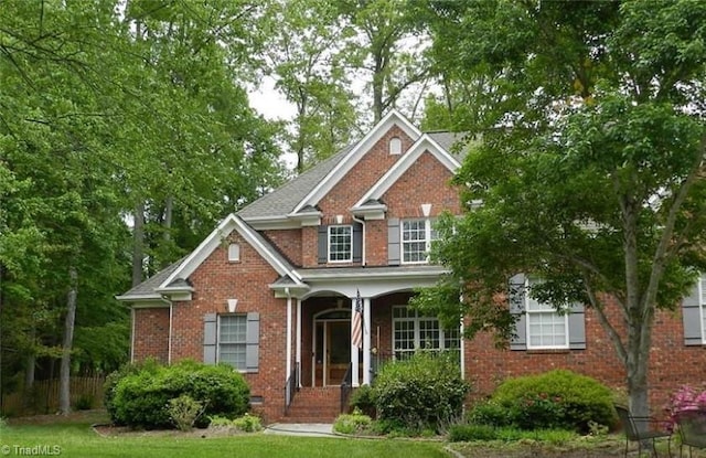 traditional-style home with brick siding and covered porch