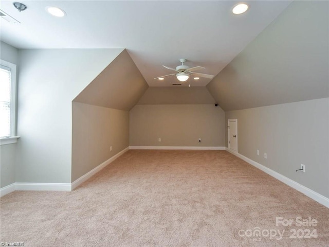 bonus room featuring light carpet, recessed lighting, baseboards, vaulted ceiling, and ceiling fan