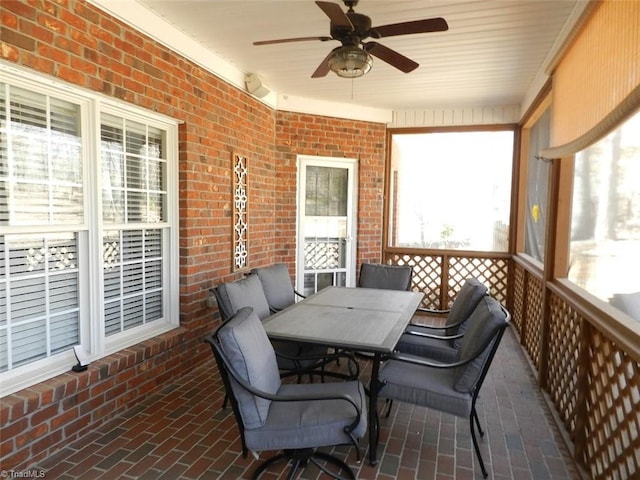 sunroom / solarium featuring ceiling fan and outdoor dining area