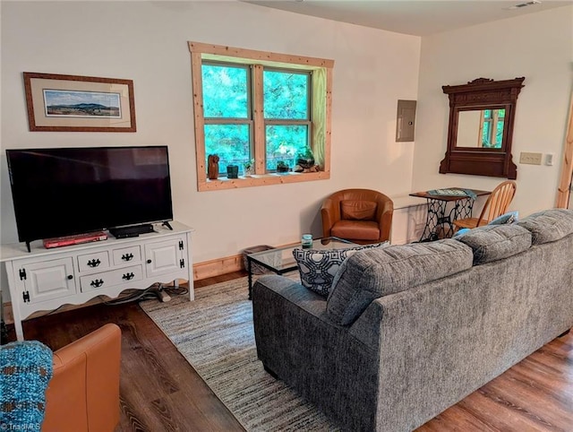 living room with electric panel and light hardwood / wood-style flooring