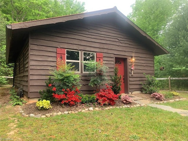 view of outdoor structure featuring a lawn