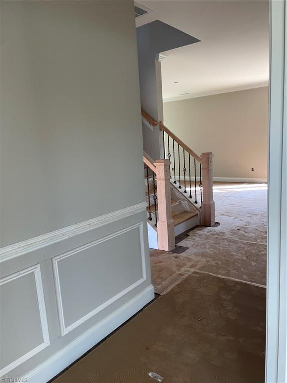 stairs featuring concrete flooring