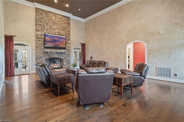 265 Phillip Henderson Rd, Rutherfordton, NC 28139 - living area with wood finished floors, ornamental molding, a stone fireplace, french doors, and arched walkways