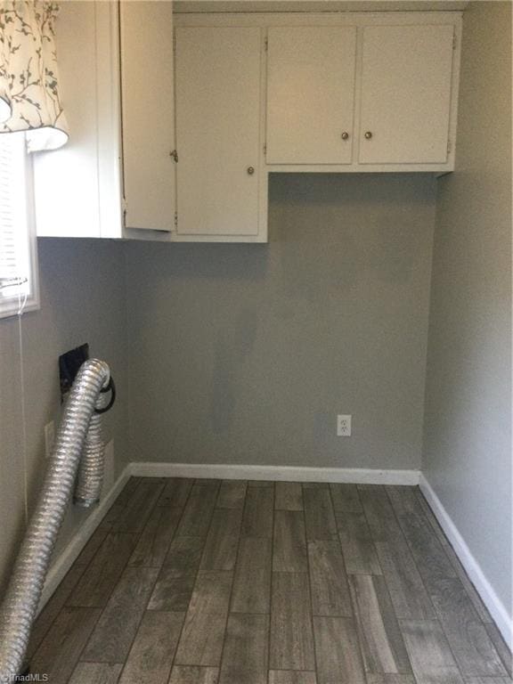 clothes washing area with cabinets and dark hardwood / wood-style floors