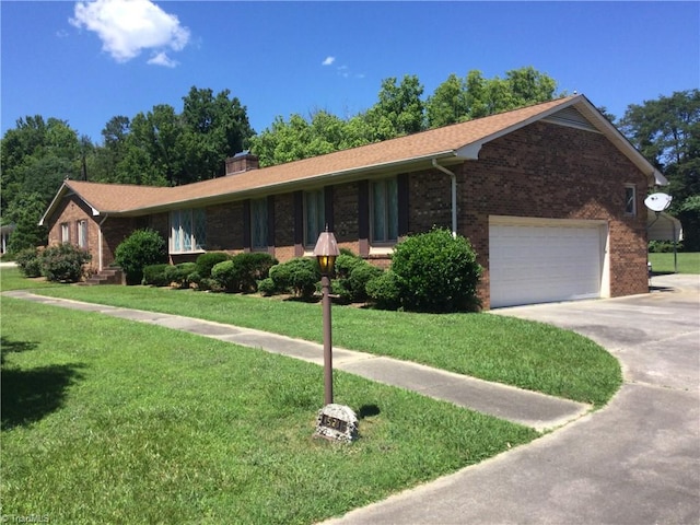 ranch-style home with a garage and a front lawn