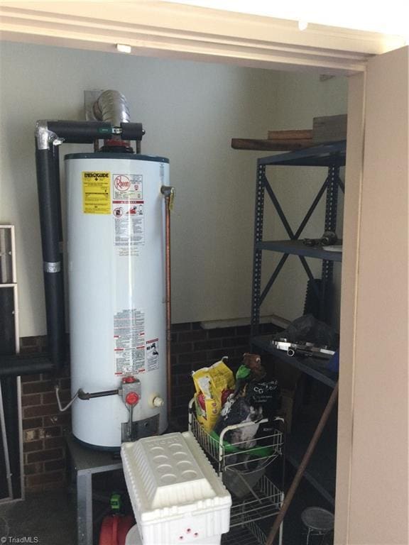 utility room with gas water heater