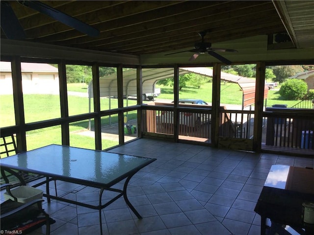 sunroom featuring ceiling fan and plenty of natural light