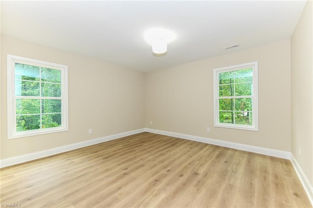 spare room with light hardwood / wood-style floors