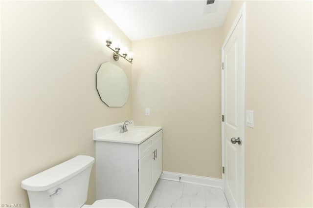 bathroom featuring toilet and vanity