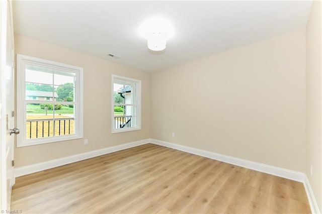 unfurnished room with light wood-type flooring