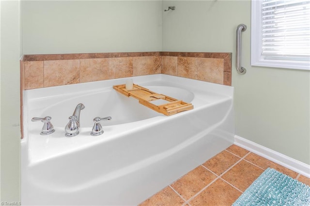 bathroom with tile patterned flooring and a washtub