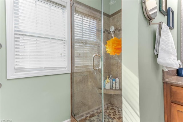 bathroom featuring vanity and a shower with door