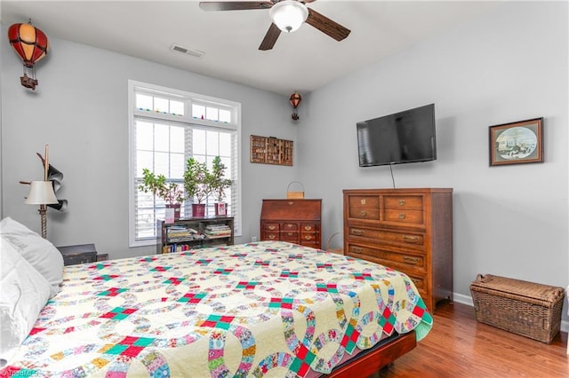 bedroom with hardwood / wood-style floors and ceiling fan