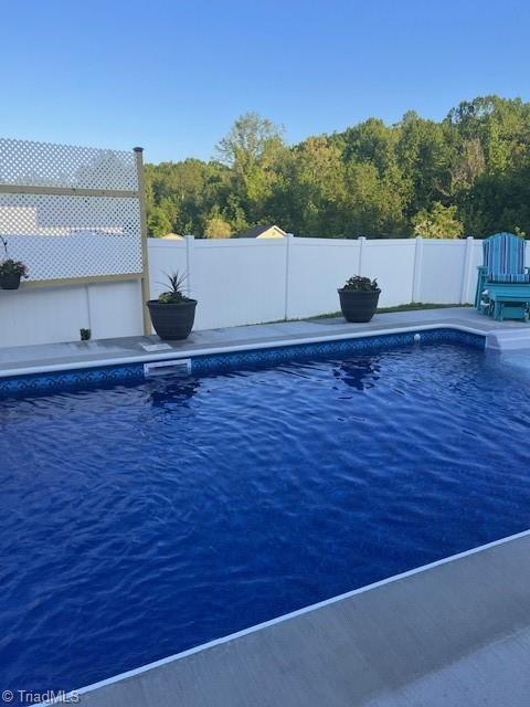 view of pool featuring a water view