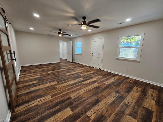 interior space with ceiling fan and dark wood-type flooring