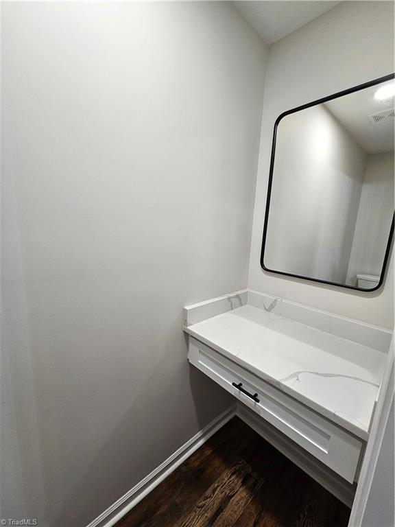 bathroom featuring vanity and hardwood / wood-style floors