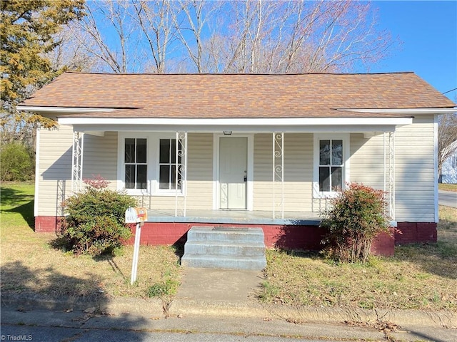 view of front of house with covered porch and roof with shingles