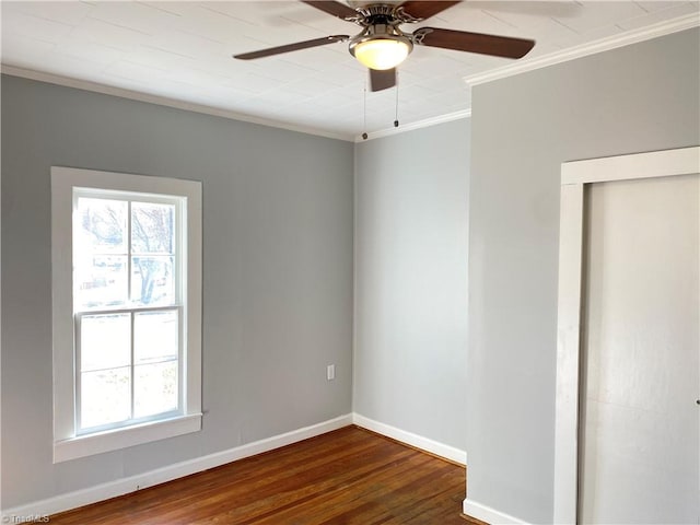 unfurnished room featuring ceiling fan, crown molding, baseboards, and wood finished floors