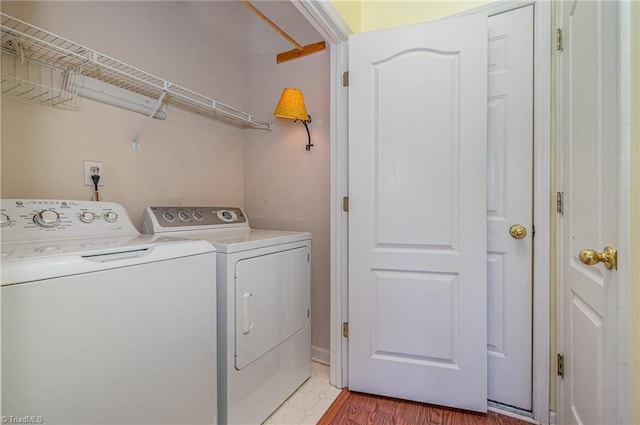 clothes washing area featuring laundry area and washer and clothes dryer