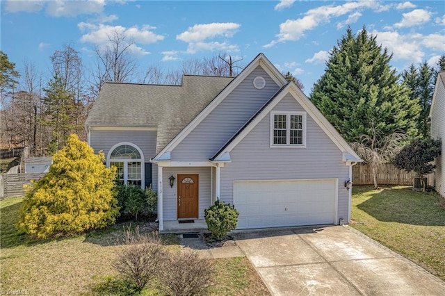 traditional home featuring a front yard, concrete driveway, fence, and a garage