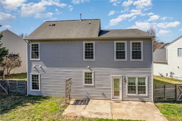 back of house featuring a patio area, a fenced backyard, and roof with shingles