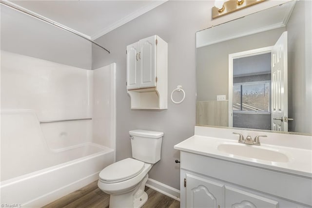 bathroom with toilet, shower / tub combination, wood finished floors, crown molding, and vanity