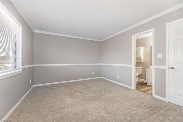 unfurnished bedroom with baseboards, carpet floors, ensuite bath, and crown molding